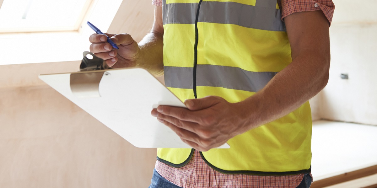 Man in high vis vest with a clipboard