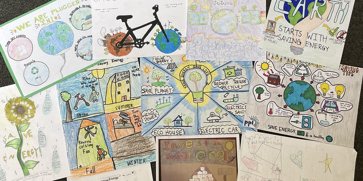 Image of student posters that contain information about energy efficiency and benefiting the environment.