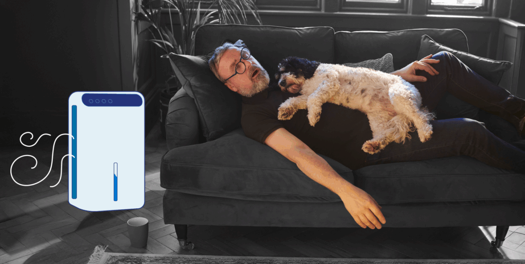 A man napping on his couch with his dog asleep on his chest, next to an illustrated dehumidifier