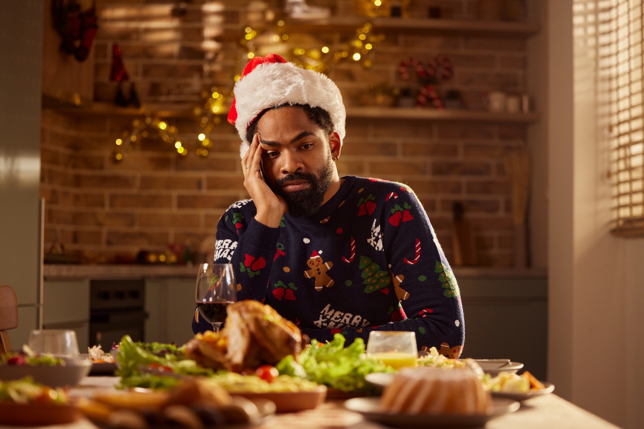 Sad man sitting alone at dining table.