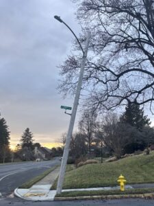 A photo of a utility pole leaning as a result of high sustained winds.