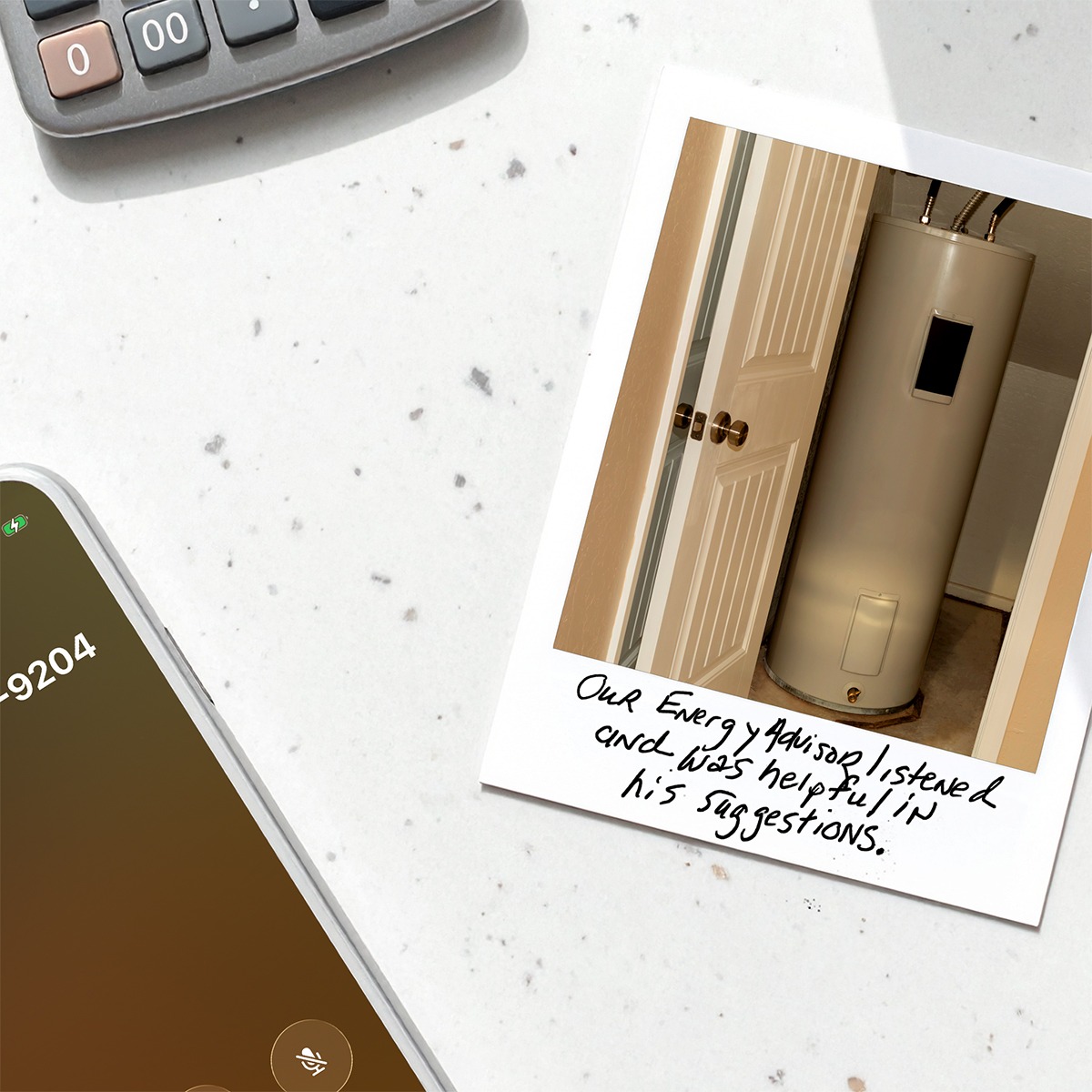 Polaroid-style photo of a water heater with handwritten text below that says, “Our Energy Advisor listened and was helpful in his suggestions.” Next to the photo is a mobile phone calling the number to schedule a Virtual Assessment.