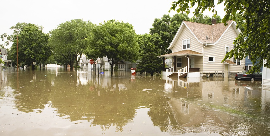 Flooding impacts a small community with waters covering streets, sidewalks and more.