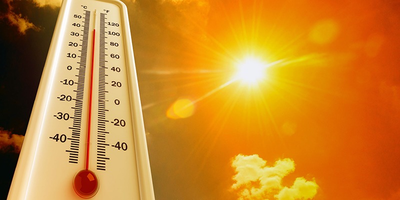 Sun beating down on a thermometer showing high temps