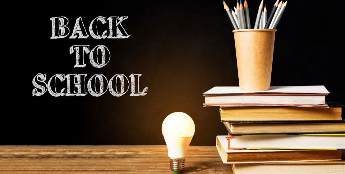 A photo of back to school supplies next to a lightbulb
